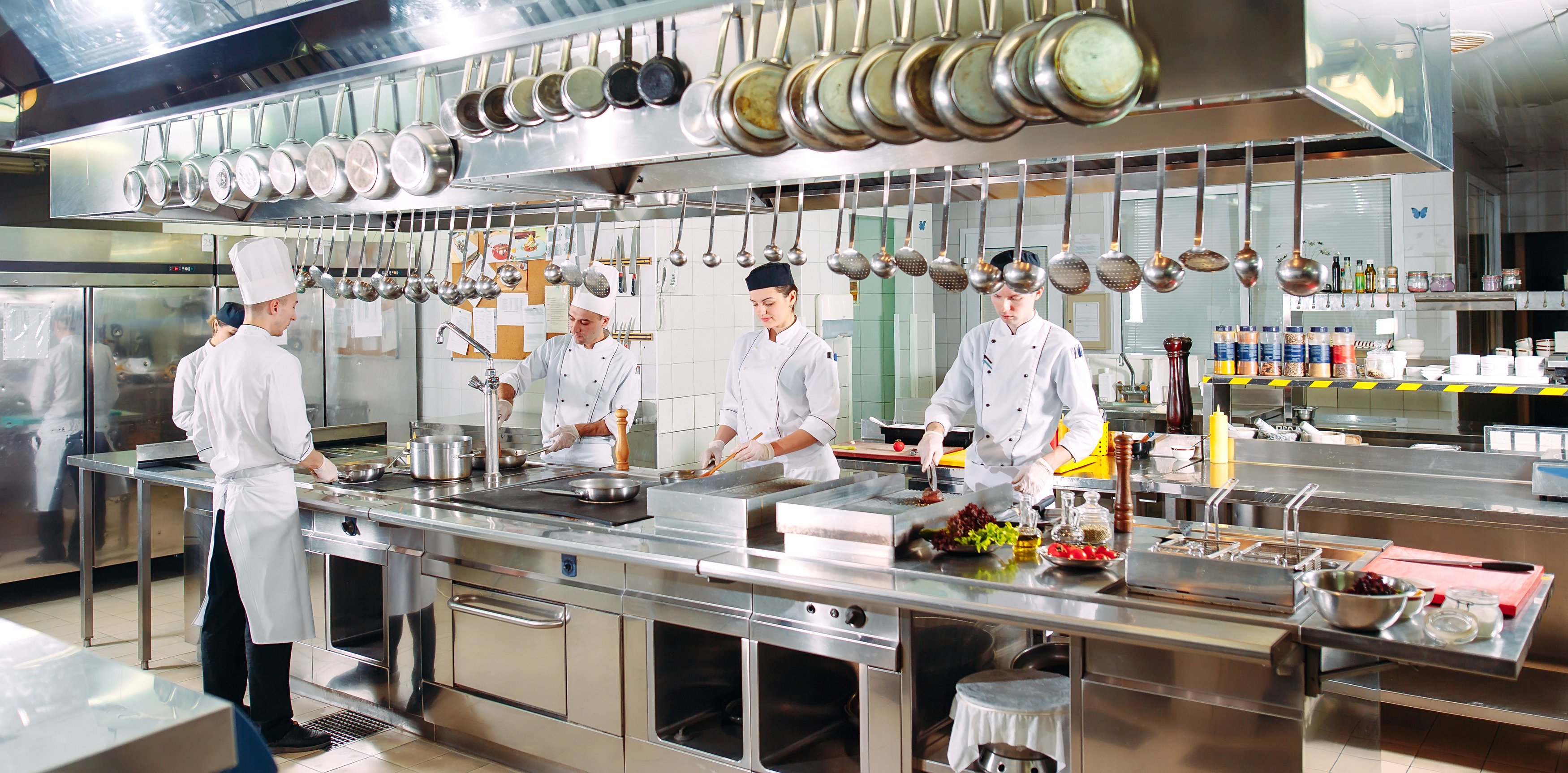 The chefs prepare meals in the restaurant's kitchen.