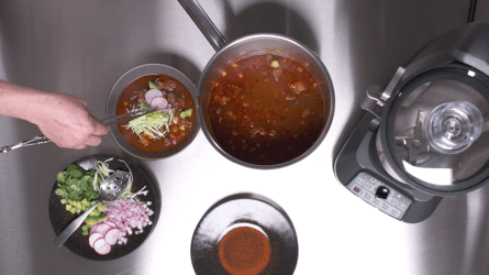 Chef creating a Pozole dish