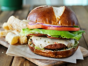 Vegan cheeseburger on pretzel bun